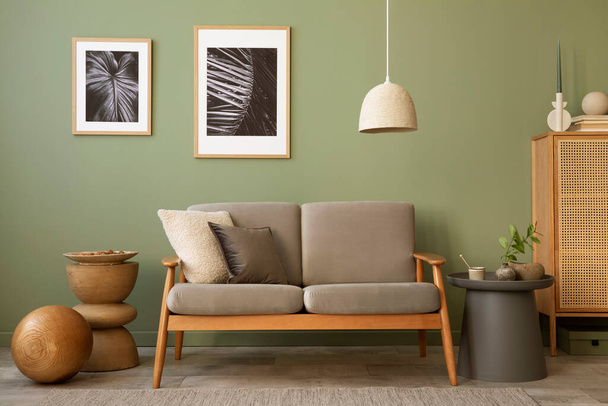 Stylish living room interior composition. Modern scandi sofa,  mock up frames, wooden commode and creative personal accessories. Eucalyptus green wall. Template. Copy space.  - Φωτογραφία, εικόνα