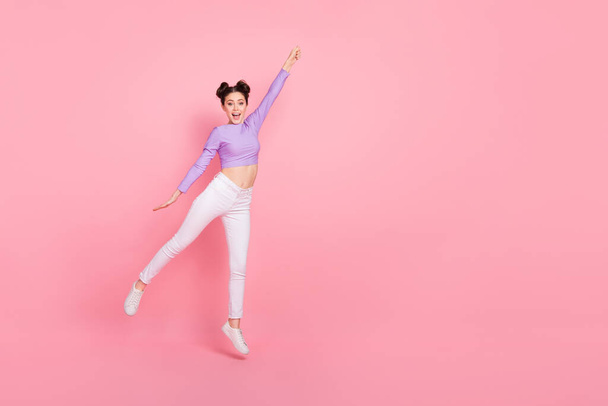 Full body portrait of excited cheerful person raise arm empty space isolated on pink color background. - Photo, image