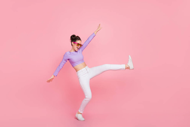 Full length body size view of attractive cheerful crazy girl having fun moving rest isolated over pink pastel color background. - Valokuva, kuva