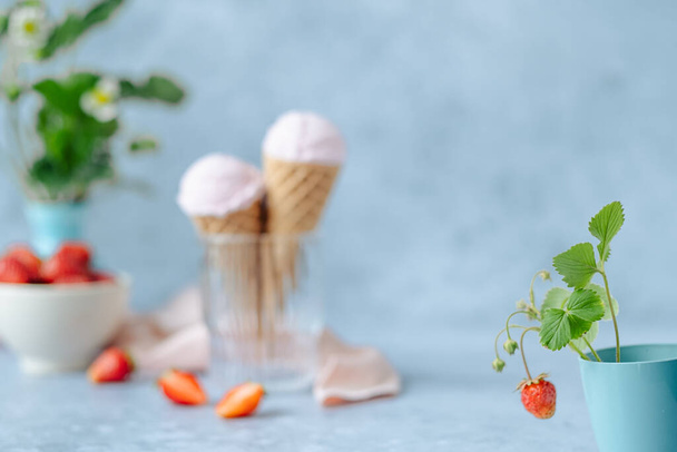 Creamy vegan strawberry ice cream in the horn in a glass on a gray background. space for text. healthy vegan dessert. High quality photo - Photo, Image