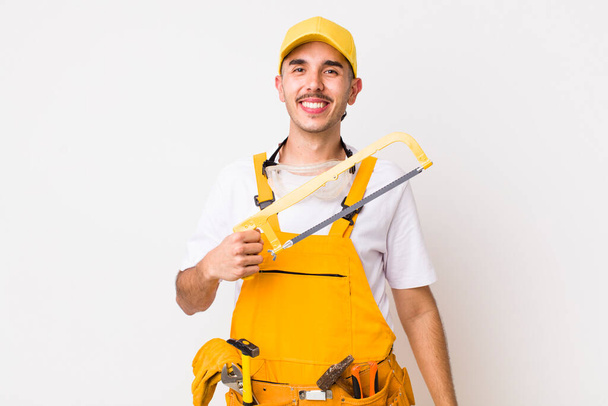 young adult handsome man with a saw. handyman concept - Photo, image