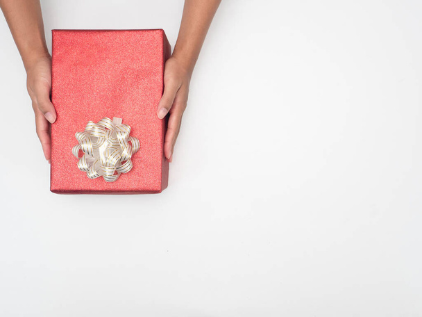 Hand holding gift box on white background copy space top view - 写真・画像