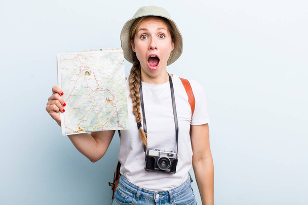 young adult blonde woman. tourist with a map concept - Фото, изображение