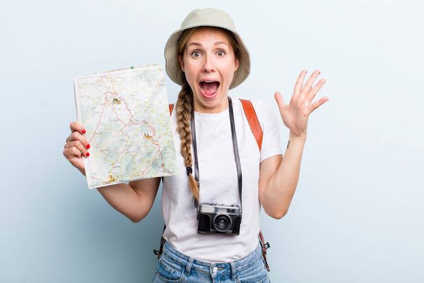 young adult blonde woman. tourist with a map concept - Фото, изображение