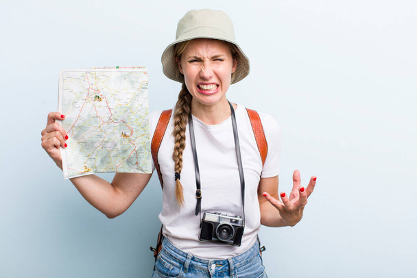 young adult blonde woman. tourist with a map concept - Valokuva, kuva