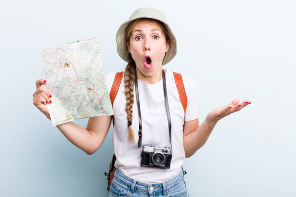 young adult blonde woman. tourist with a map concept - 写真・画像