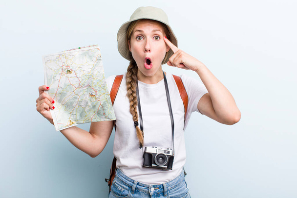 young adult blonde woman. tourist with a map concept - Foto, immagini