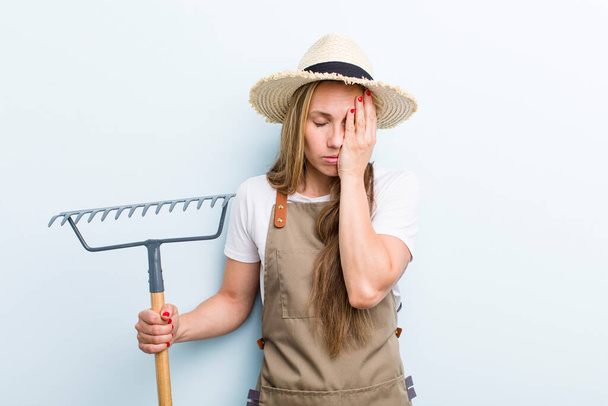 young adult blonde woman. farmer with a rake - Photo, Image