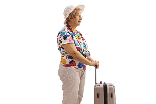 Elderly female tourist with a suitcase isolated on white background - Foto, afbeelding