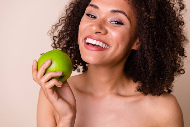 Photo of cheerful sweet lady wear nothing enjoying juicy fruit smiling isolated beige color background. - Foto, Imagem