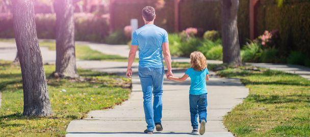 Banner of father and son walk in park back view. family value. childhood and parenthood - Zdjęcie, obraz