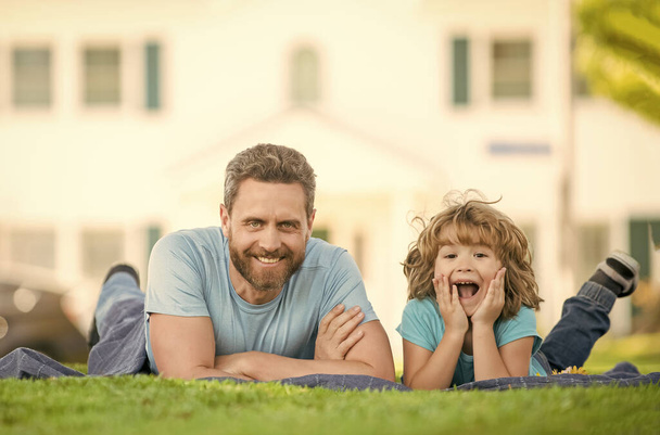 childhood and parenthood. parent relax with little child boy on grass. dad with kid on summer day. parenting and fatherhood. fathers day. happy father and son having fun in park. family value. - Foto, Bild