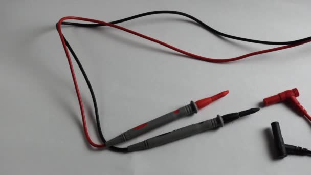 Probes from a multimeter. Close-up on a white background. - Footage, Video