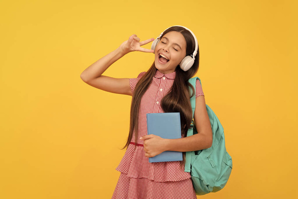 music. happy singing teen girl carry backpack. back to school. knowledge day. concept of education. kid in headphones with workbook. september 1. happy childhood. child with school bag. - Foto, Imagem