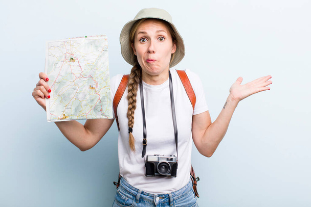 young adult blonde woman tourist with a map. holidays concept - Фото, зображення