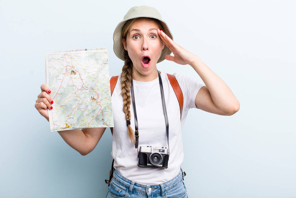 young adult blonde woman tourist with a map. holidays concept - Foto, Bild