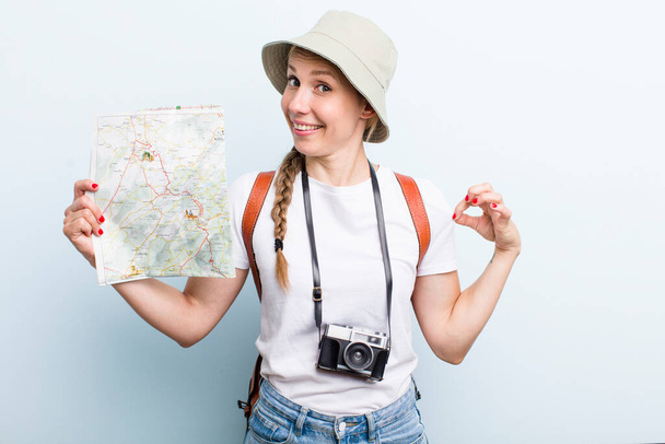 young adult blonde woman tourist with a map. holidays concept - Zdjęcie, obraz