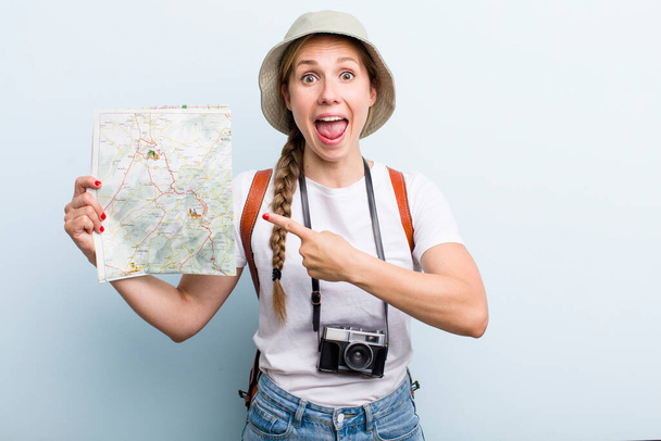 young adult blonde woman tourist with a map. holidays concept - Фото, изображение