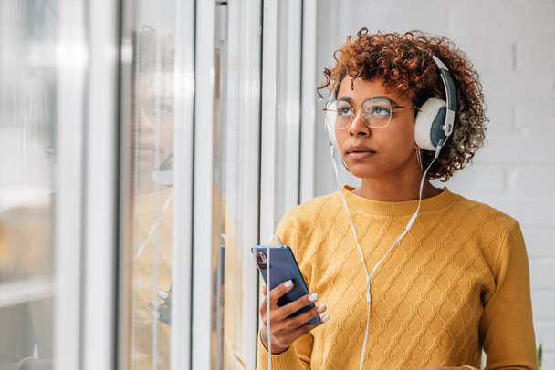 african american woman or girl with headphones and mobile phone - Φωτογραφία, εικόνα