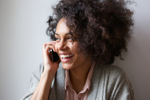 Young woman laughing and talking on mobile phone - Photo, image