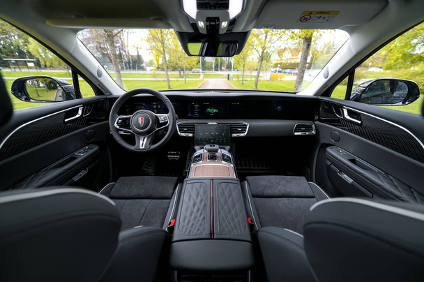 Notteroy, Norway - may 27, 2022: black electric SUV Hongqi around green foilage  - Фото, изображение