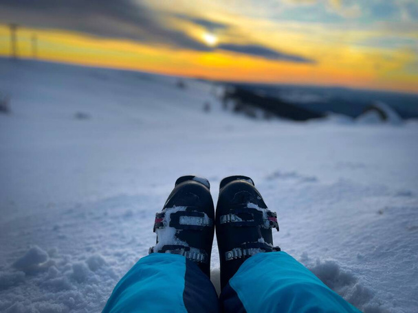 Skiing boots at sunset in the mountains - Foto, Bild