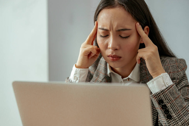 Tired business woman with headache working laptop in office. High quality photo - Fotoğraf, Görsel