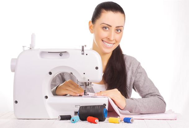 happy seamstress sewing. isolated on the white - Foto, Imagen