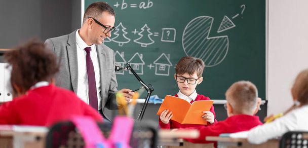Male maths teacher conducting lesson in classroom - Φωτογραφία, εικόνα