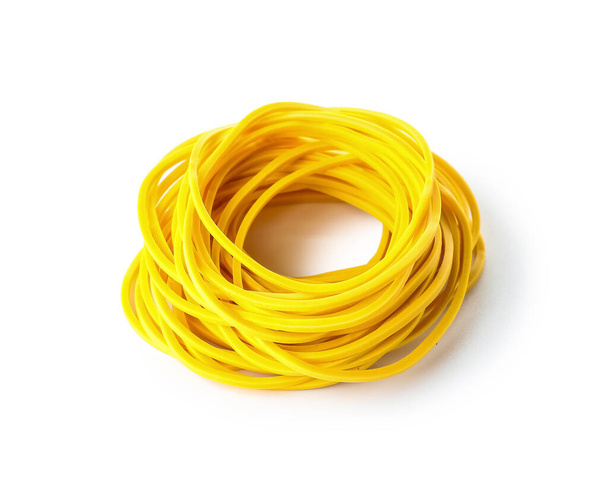 Many yellow rubber bands on white background - Foto, Imagen