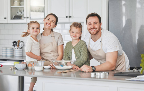 Shot of adorable little girls baking with their parents at home. - Foto, Bild