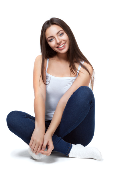 beautiful girl sitting on a white background isolated - Foto, afbeelding
