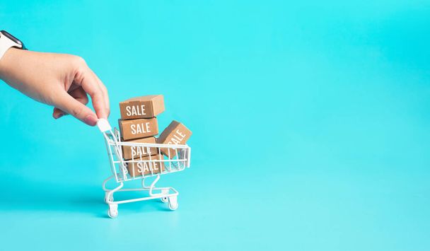 Business promotion or online shopping concepts with female hand and product box order in trolley.marketplace and transportation service.copy space - 写真・画像