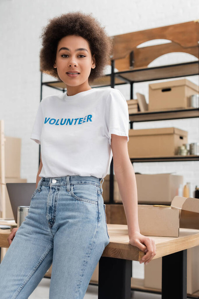 young african american woman standing at workplace in volunteer center and looking at camera - 写真・画像