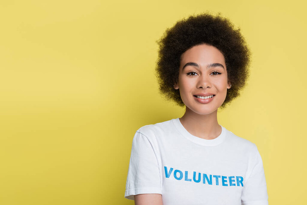 young african american woman in t-shirt with volunteer inscription isolated on yellow - Fotografie, Obrázek