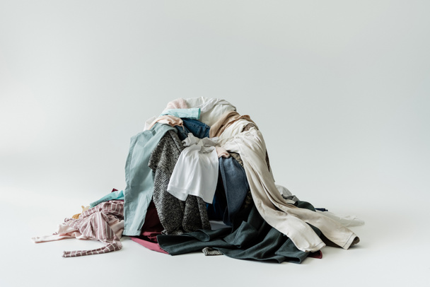 pile of various garments on grey background - Fotó, kép