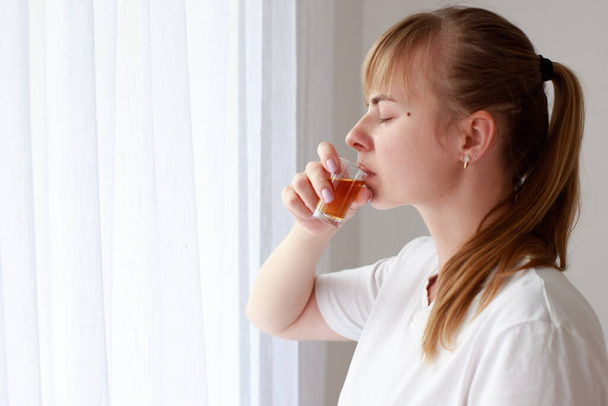 woman drinking strong alcohol in depression. female alcoholism. - Photo, image