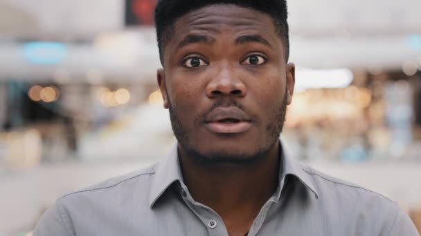 Male portrait close-up young surprised amazed african american man feeling shock surprise happy guy smiling nodding answers yes positive answer great decision choice agree expresses approval good idea - Filmmaterial, Video