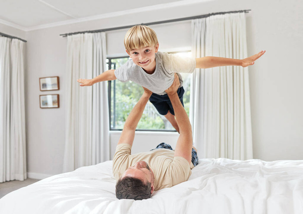 Shot of a father and son playing in a bedroom at home. - Фото, зображення