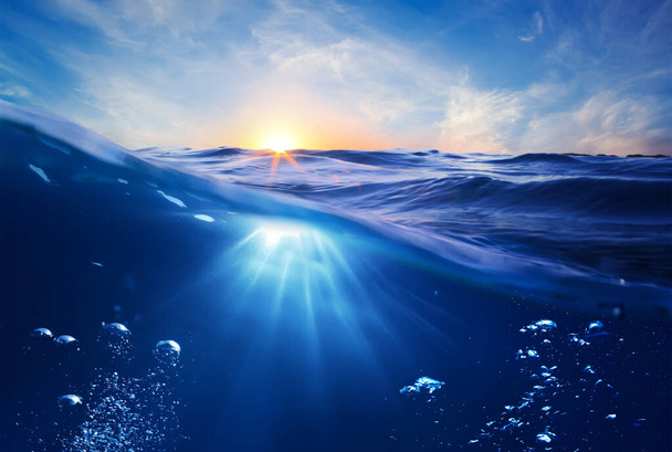 blue water surface with waves, sun rays, ripples. - Foto, Imagem