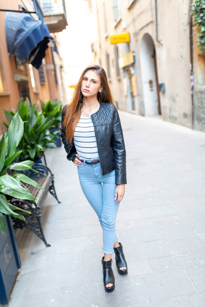 beautiful brunette Italian girl walks in the town. High quality photo - Fotó, kép