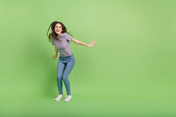 Full length body size view of attractive cheerful girl dancing clubbing copy space isolated over bright green color background. - Zdjęcie, obraz