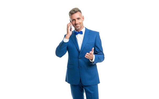 happy man in blue bow tie suit talk on phone isolated on white. - 写真・画像