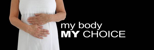 Banner de mensaje My Body My Choice: mujer vestida de blanco con las manos sobre el torso en postura protectora contra el fondo negro con espacio para copiar - Foto, imagen