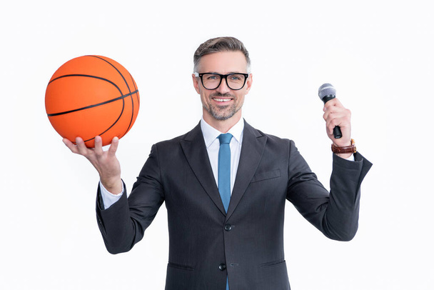 glad mature man in suit hold basketball ball and microphone isolated on white background. - Foto, Bild