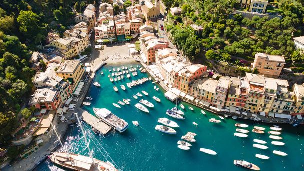 Aerial view of a popular Italian town on the Ligurian coast with moored boats in the azure water. Top down view - Zdjęcie, obraz