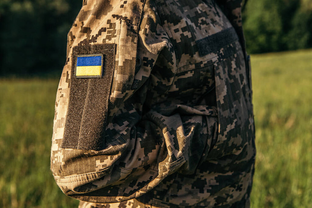 Close up velcro patch with flag of Ukraine on military uniform soldiers arm. Armed Forces of Ukraine. Ukrainian in Army. - Foto, Imagem