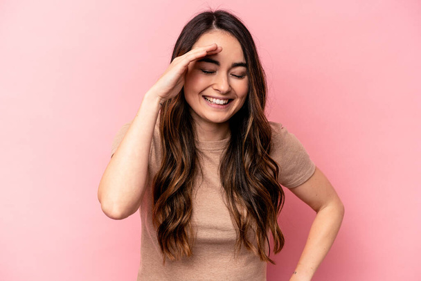 Young caucasian woman isolated on pink background joyful laughing a lot. Happiness concept. - Photo, Image