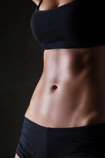 Slim womans body  over dark gray background - Foto, immagini