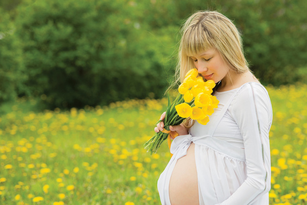 Beautiful pregnant woman outdoor - Photo, image